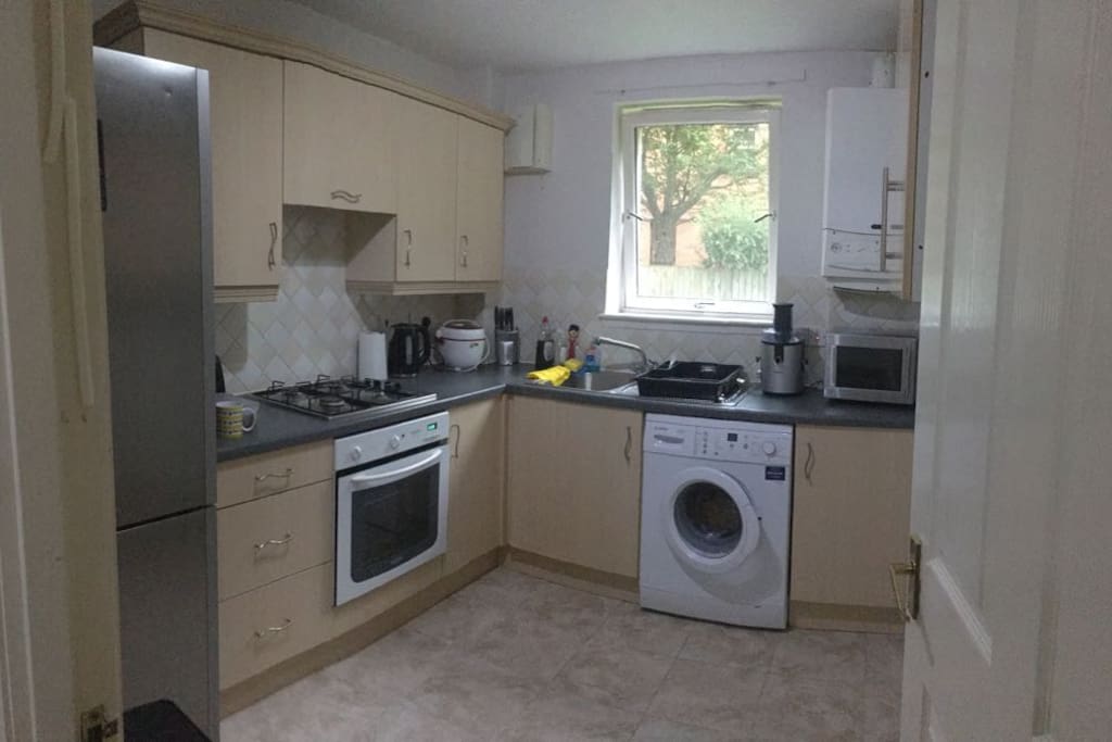 Kitchen with microwave, oven and washer.