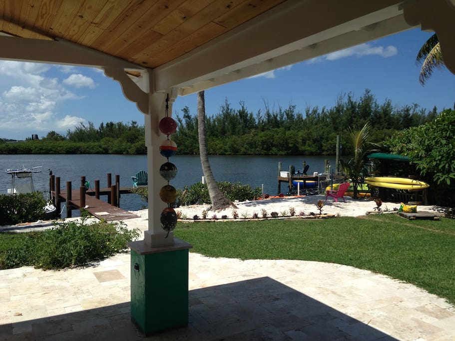 Outdoor covered room with beautiful view, comfy furniture, ping-pong, and kitchen.