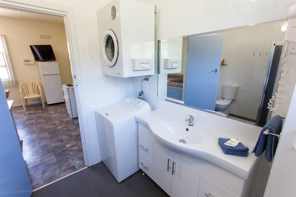 Large renovated bathroom with washer and dryer