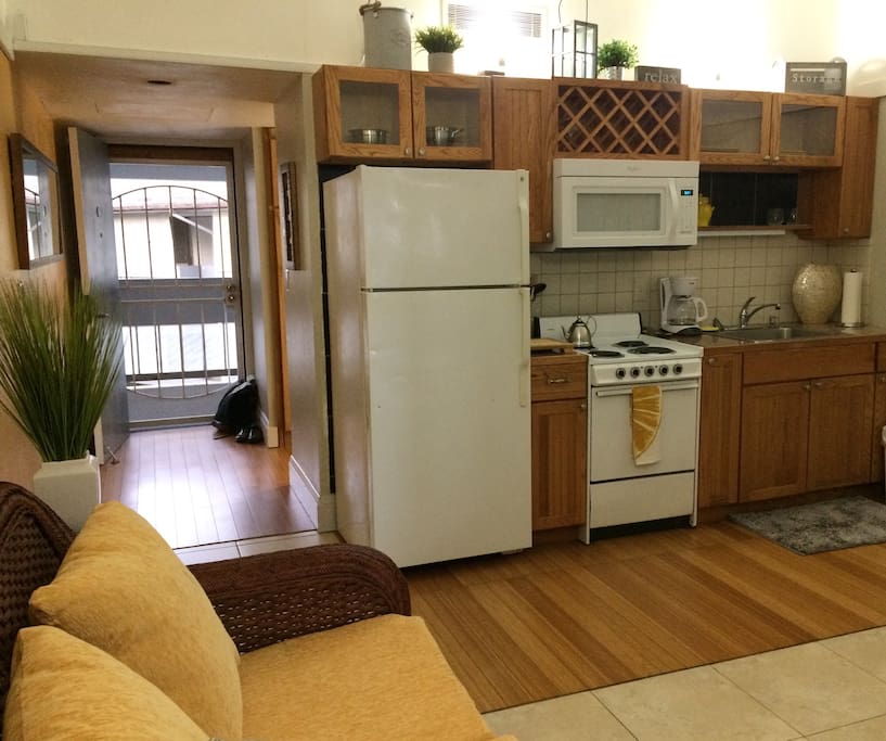 Kitchen area provides dinnerware, cookware, and full size appliances for cost effective at home meal prep.