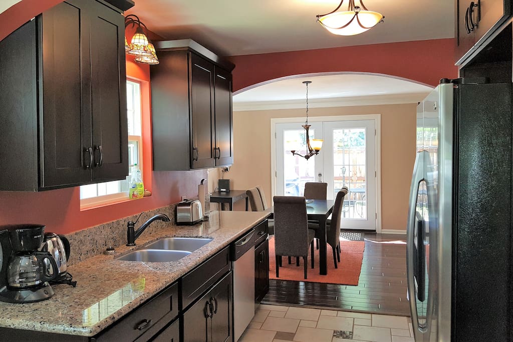 view of kitchen from living room- beyond the kitchen you can see the dinning room and french doors to outside