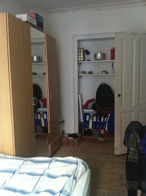 Bedroom with shower cabin and sink in the corner