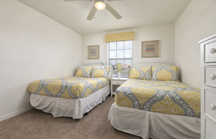 Have a comfortable stay in our suite with two double beds, a functional space, and a ceiling fan.