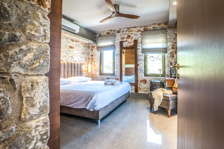 First Floor: Serene master bedroom with a king-size bed and a private en-suite bathroom.