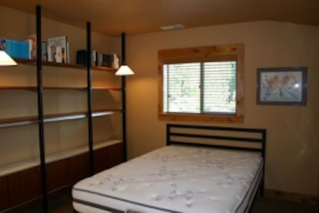 Upstairs guest bedroom with double exposure and view of the mountains and forest.