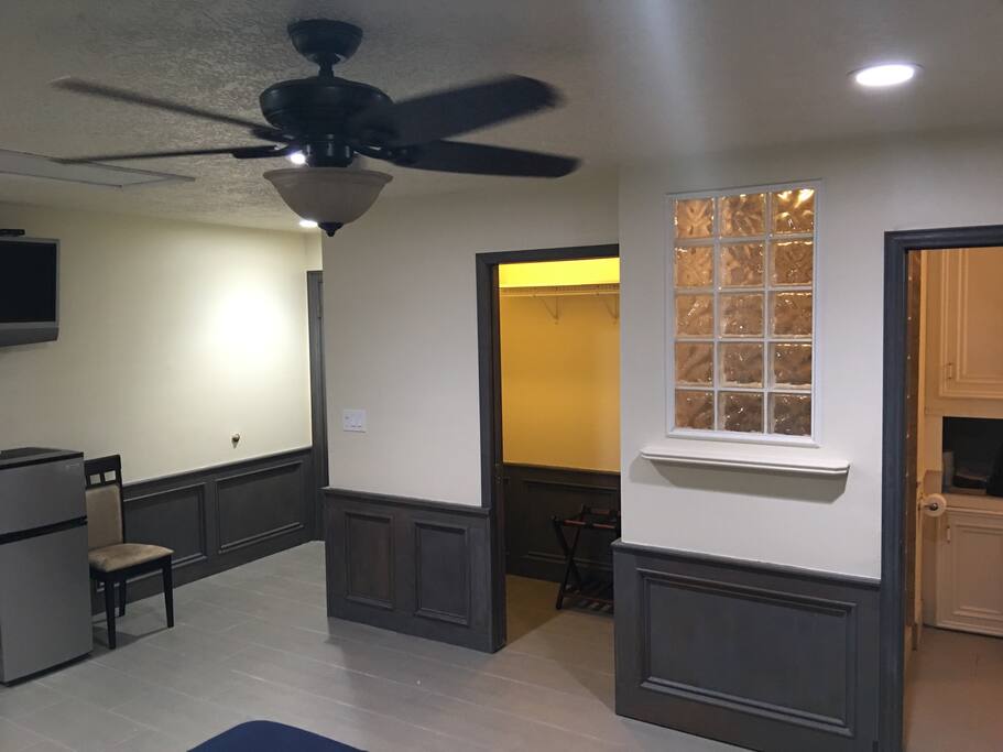 Walk in closet w pocket door on left, bath to right with glass block window into shower.