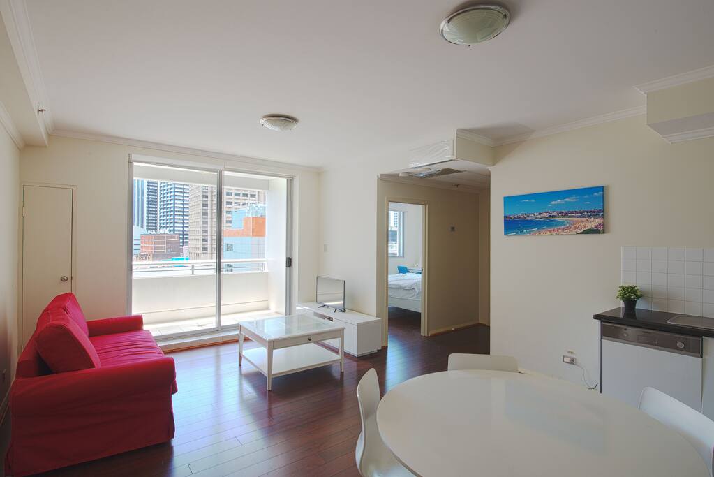 Livingroom - TV, sofa bed, balcony with view of Sydney CBD