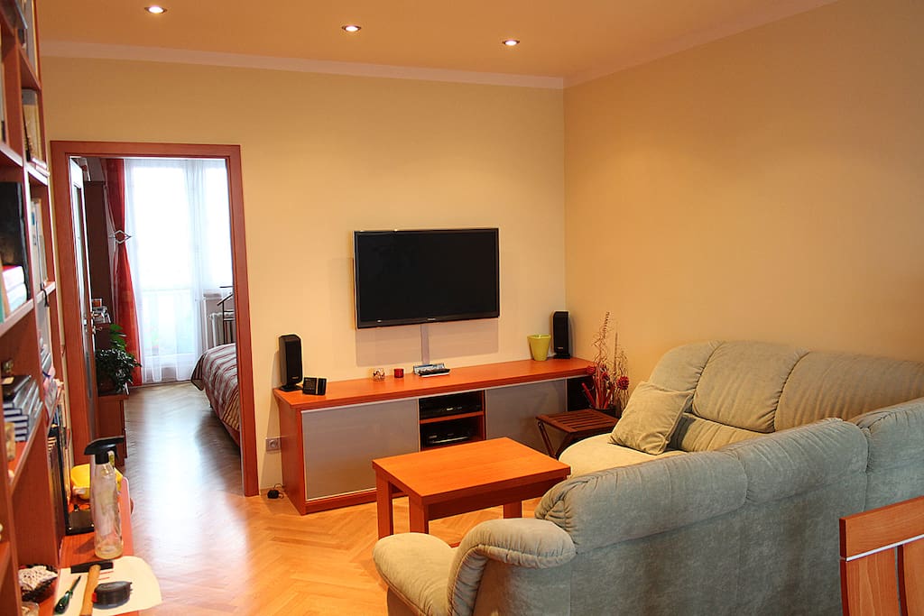 Living room with large sofa and TV.