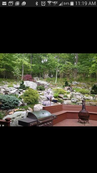 Deck with integrated seating, chiminea, and BBQ grill