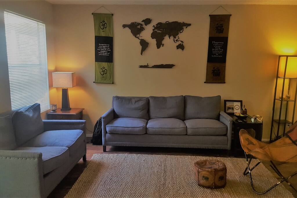 The living room has hardwood floors, custom-made couches and tons of natural lighting.