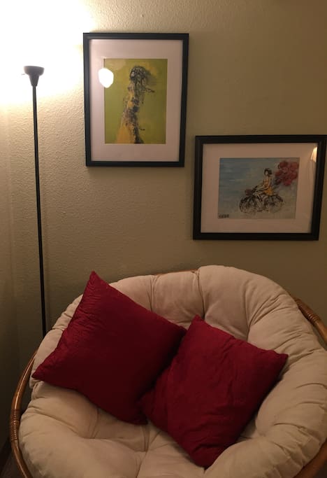 Comfortable chair for reading with artwork from local artist, Siler.