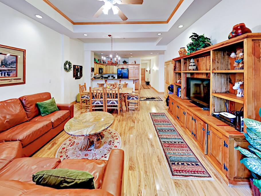 The open living area is built to charm with warm walnut floors, 11' ceilings, and a gas fireplace.