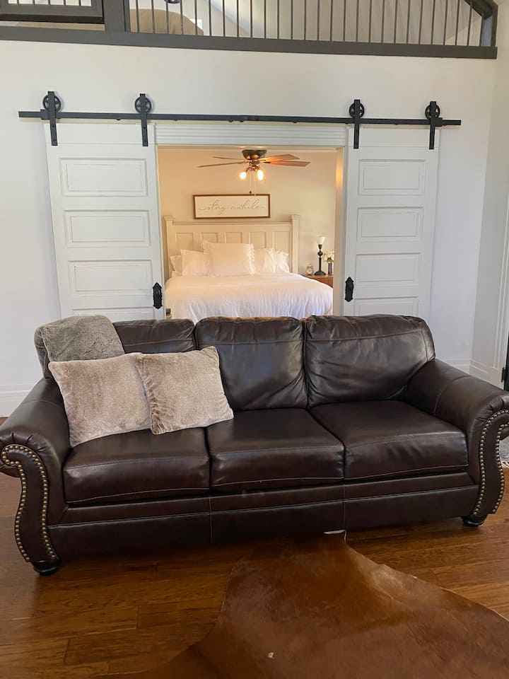 Living room with leather sleeper sofa.