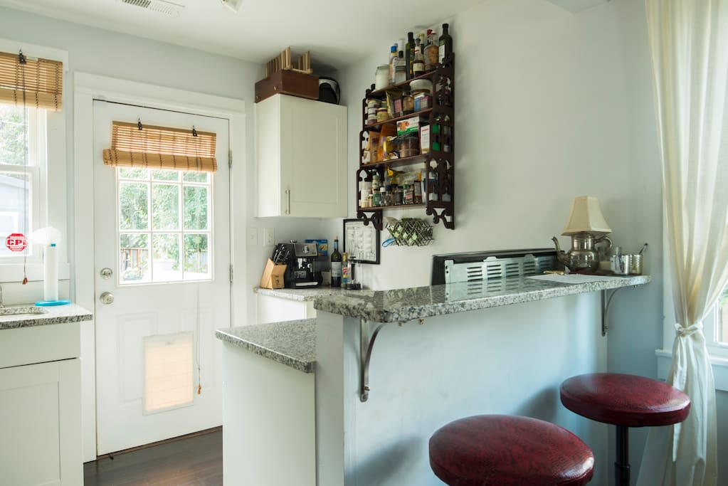 Kitchen with some basics. Two seats at island. Nice view to backyard.