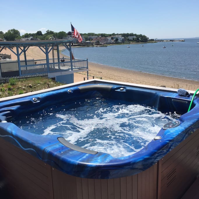 Hot tub overlooking the water on outside deck