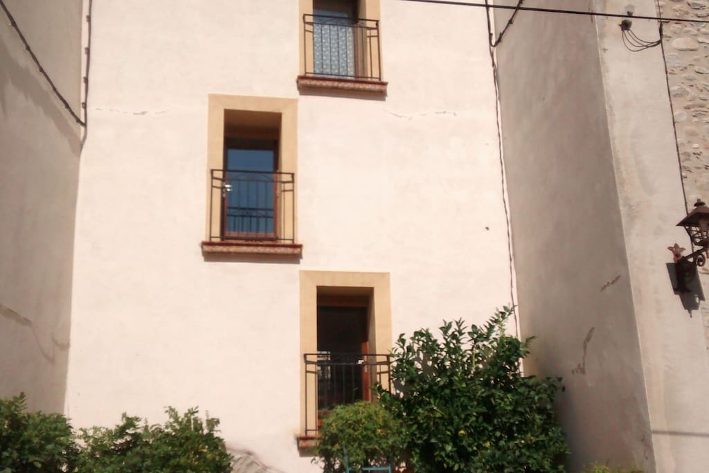 front of house, upper floors, showing kitchen balcony and orange tree