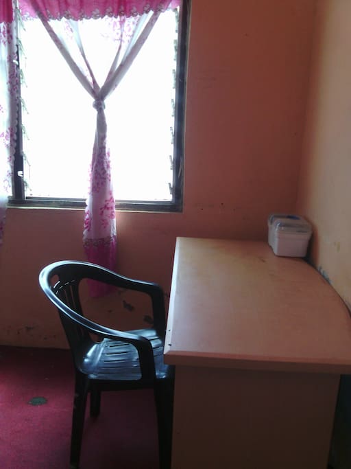 An office table, a chair and first-aid box with first- aid items in it, all these are in the room.