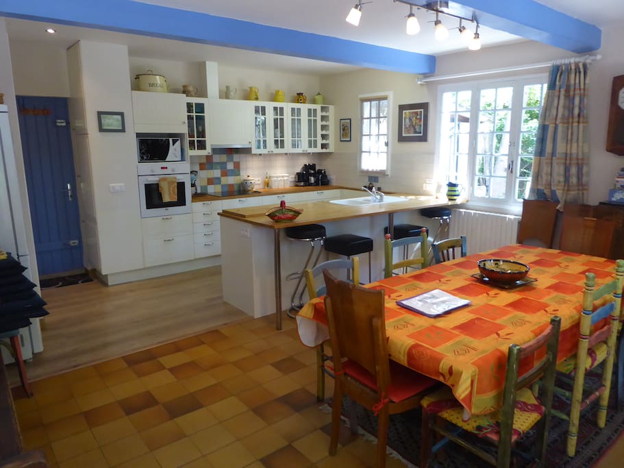 Open plan well equipped kitchen and dining area