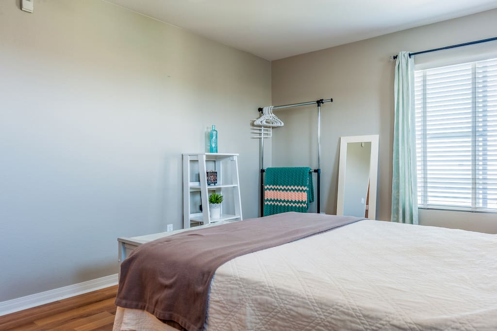 Garment rack & mirror in master bedroom
