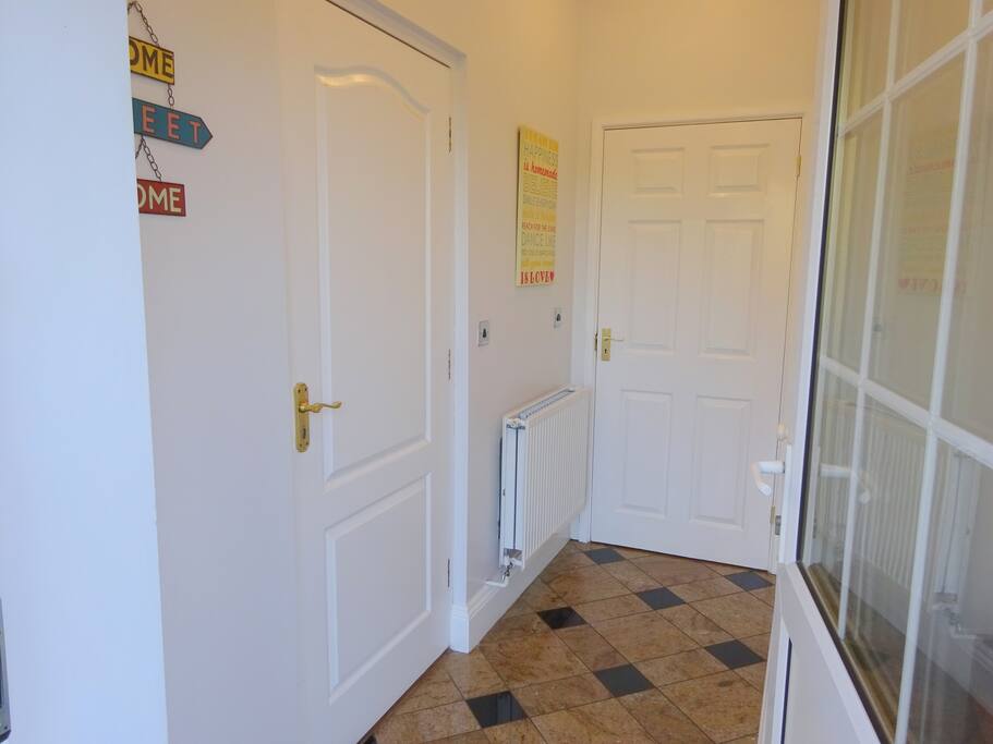 Private entrance hall with shoe rack and fitted cupboard with hanging space