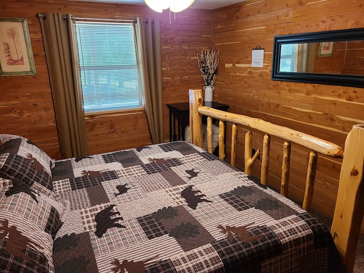 Master bedroom with rustic cedar post bed. Two cedar night stands with Edison lamps. 