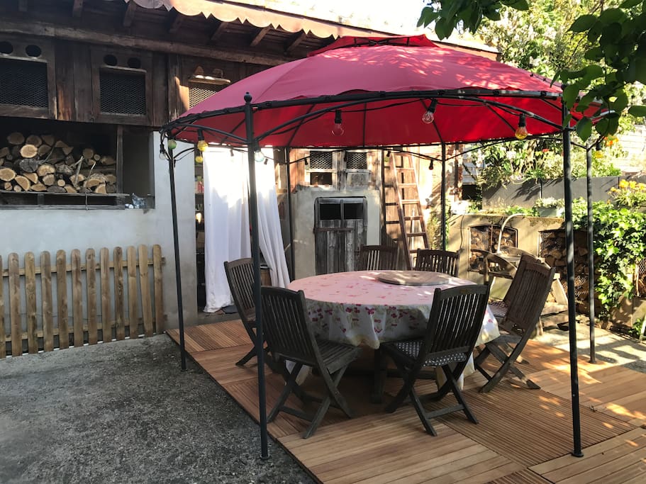 Côté jardin terrasse et barbecue à côté de la piscine