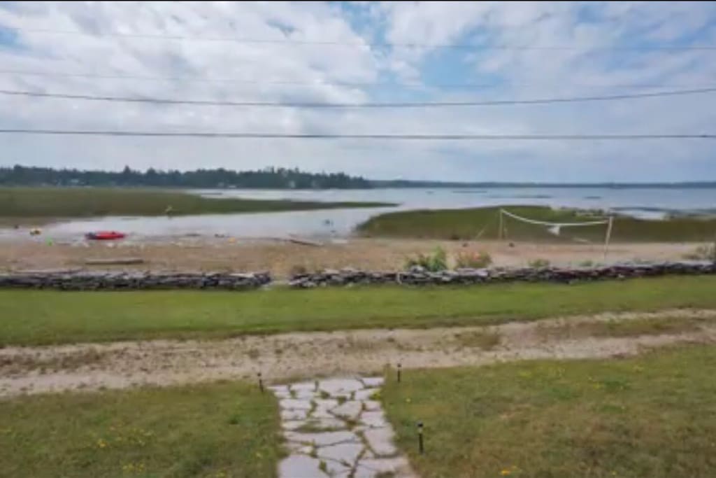 View of the beautiful beach in front of our doorstep, with warm shallow water that gradually gets deeper. Note: water levels are very high this year in Lake Huron and as of the summer 2017, there is less sandy beach then shown in the picture.