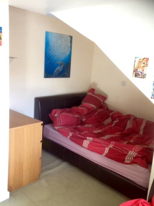Double bedroom with chest of drawers and small sofa