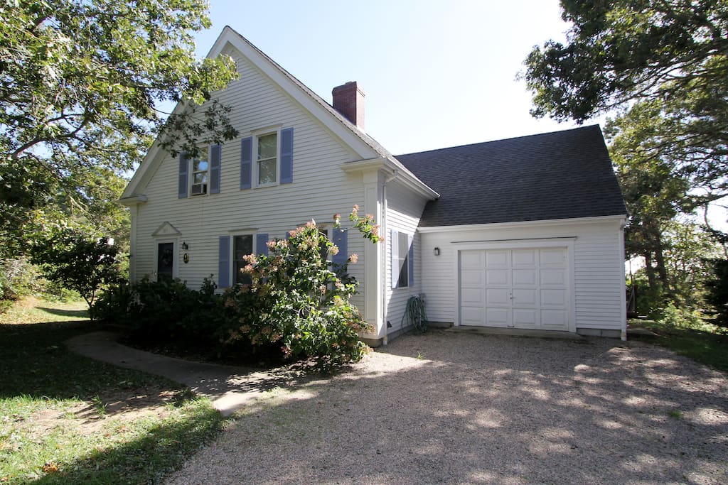 Classic Blue and White Cape, tree-lined street and yard, driveway for 3 or 4 cars (garage not available).