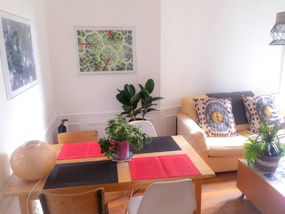 Living area with sofa, kitchen table, and standing balcony