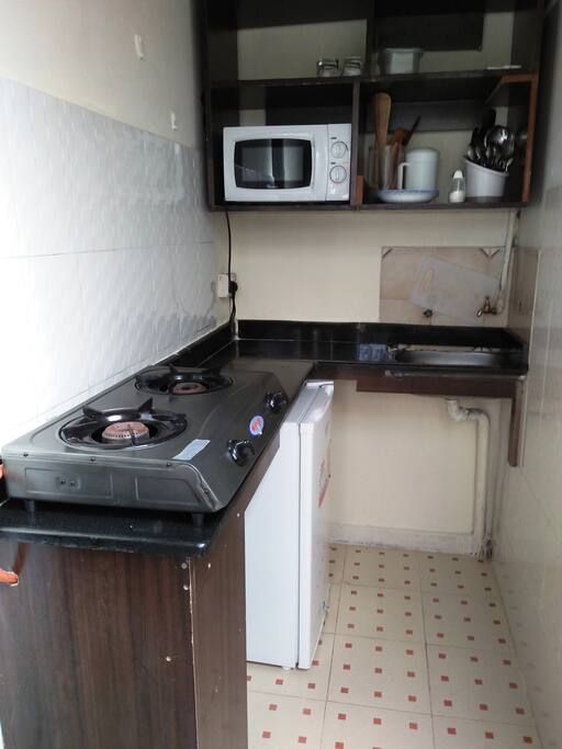Fully kitted kitchenette with marble table top for classy style and practical use