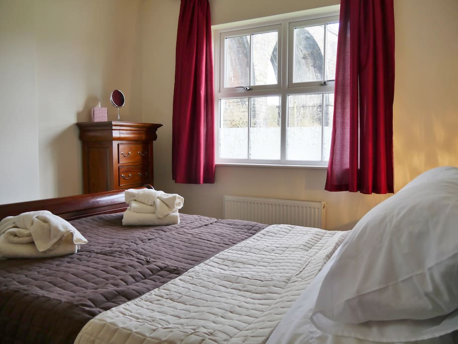 Master bedroom with king size sleigh bed and sleigh furniture. Views of viaduct