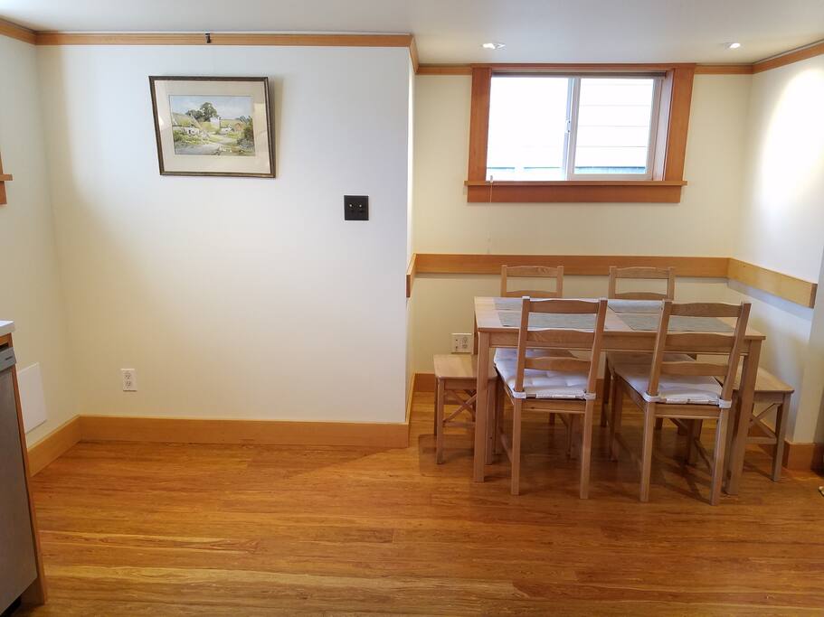 Cute dining room that can accommodate six. Reclaimed wood floor.