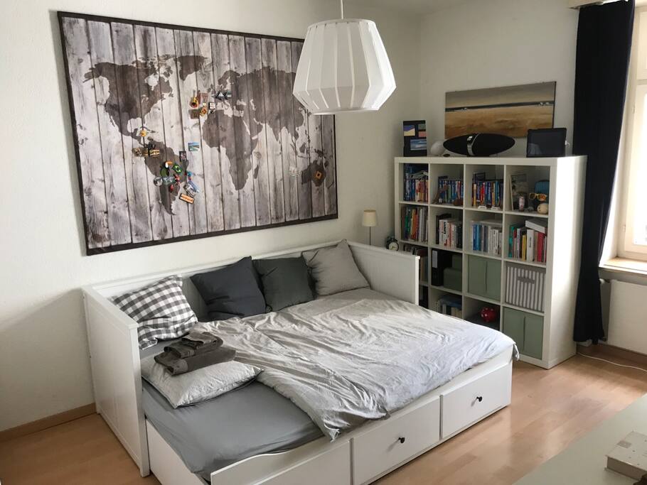 Studio with double bed sofa, desk, sound system and storage space.