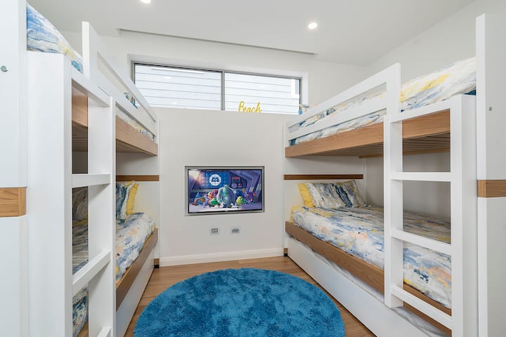 Third bedroom with two sets of bunk beds with trundles and a recessed television with connections for electronic games