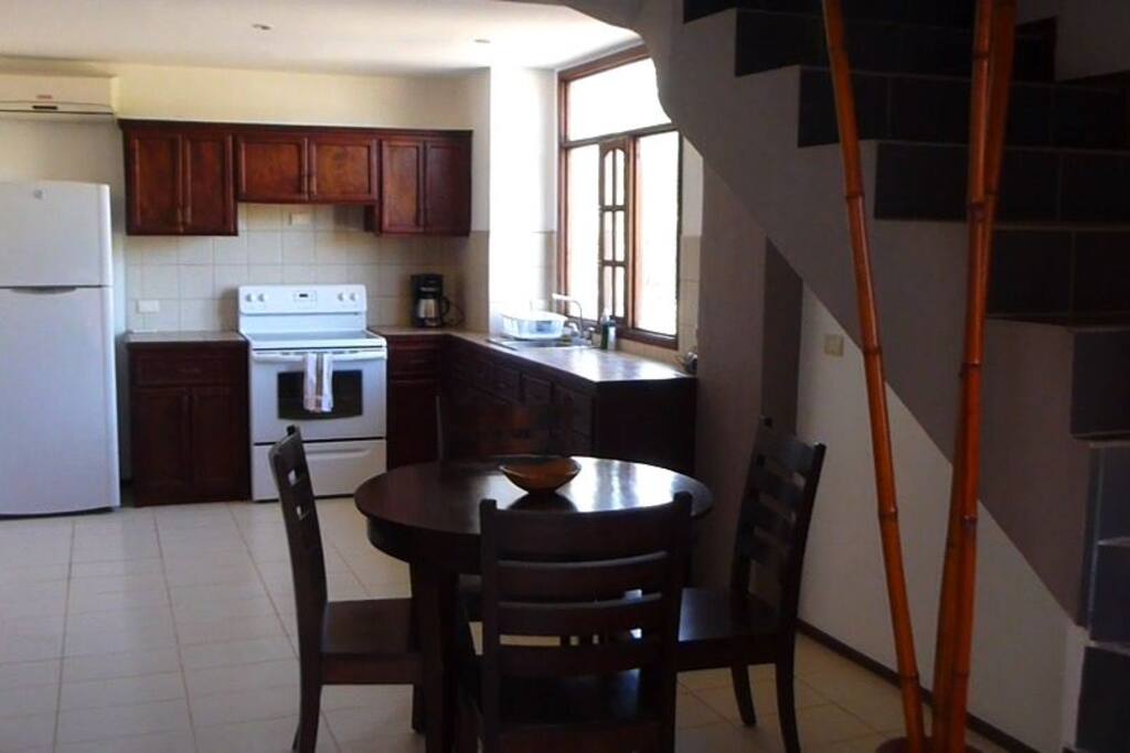 Open kitchen with super bright windows overlooking the neighbourhood