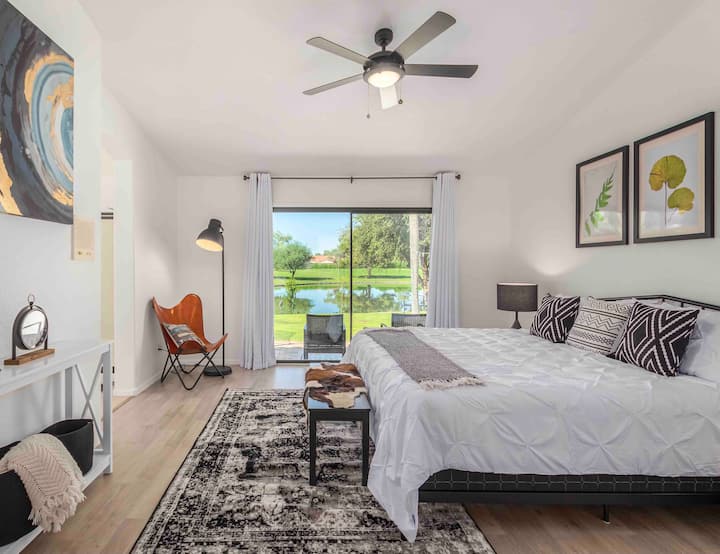 Tranquil view of the lake from the bedroom. Blackout curtains for restful nights. TV is in the master bedroom 