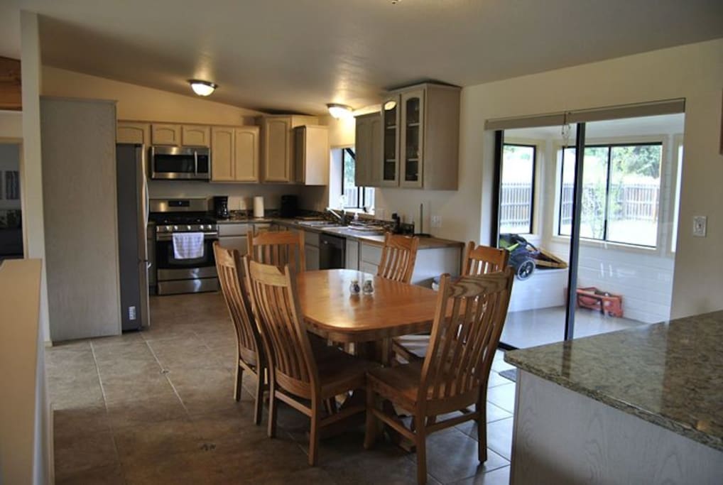 Kitchen with new appliances and expandable table.