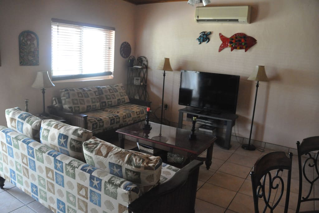 Spacious living room with large TV.