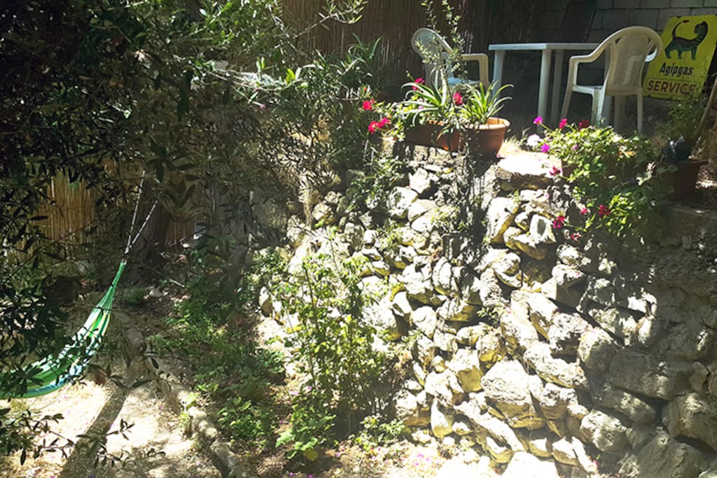 Hammock/ vegetable garden on lower level and chairs/flowers on upper level