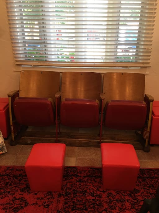 Here's a close-up of the vintage high school auditorium seats in the living room. (They're comfortable, too!)
