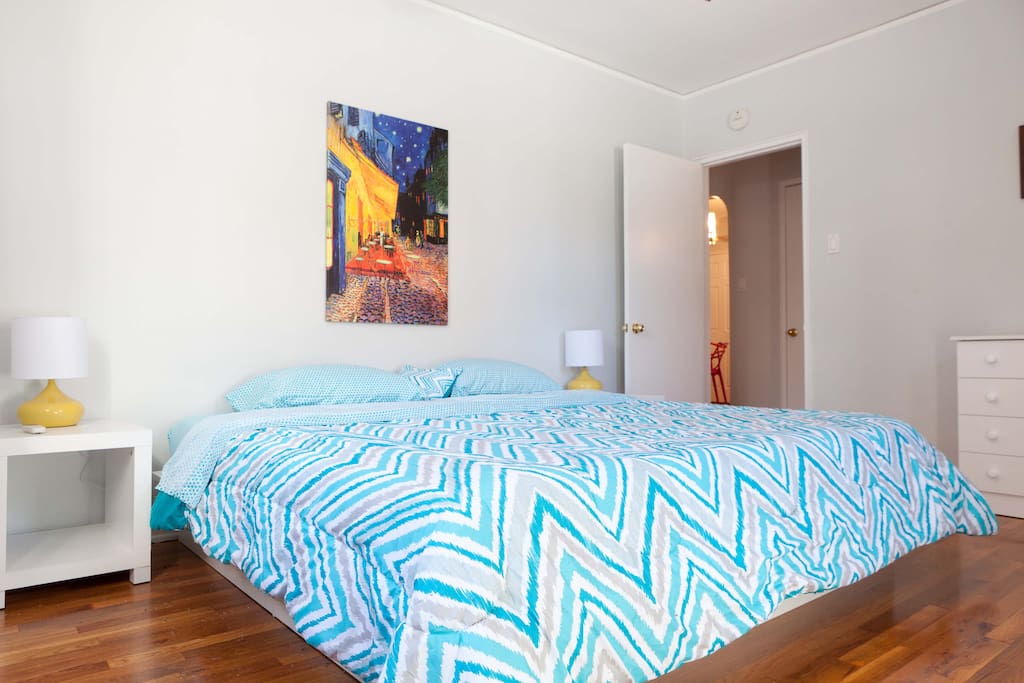 Master bedroom with king size bed, one dresser and A/C.