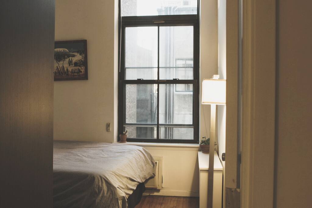your bedroom, with a Tempur-pedic mattress and pillows, high ceilings and bright large windows