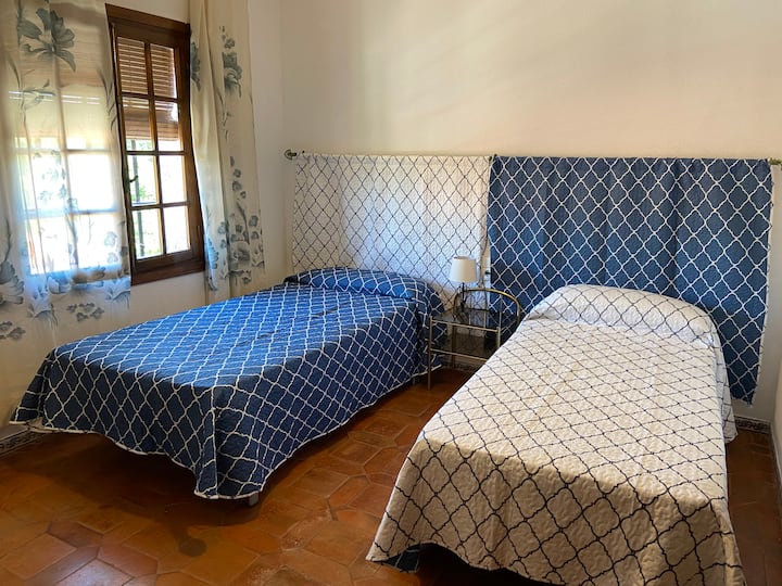 A double bedroom with a bathroom in the hallway