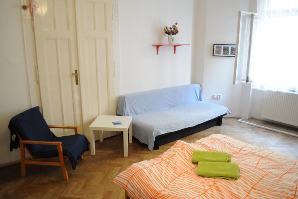 There is an arm-chaire, small table and a sofa.
