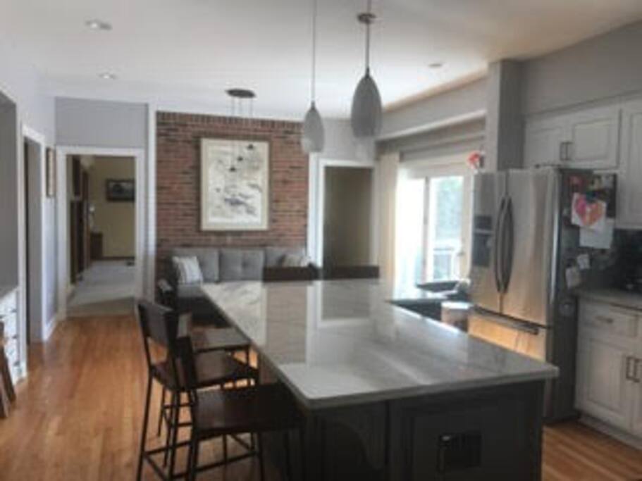 Kitchen and breakfast nook look out over deck and spacious backyard.