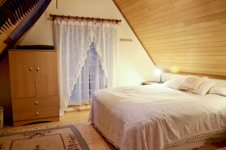 The upstairs bedroom is a cocoon of serenity and relaxation with its own outside deck.
