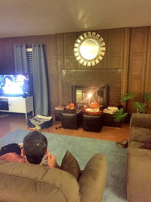 huge large living room with fireplace and large screened tv