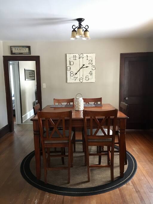 Pub height dining room table seats up to 8 guests.