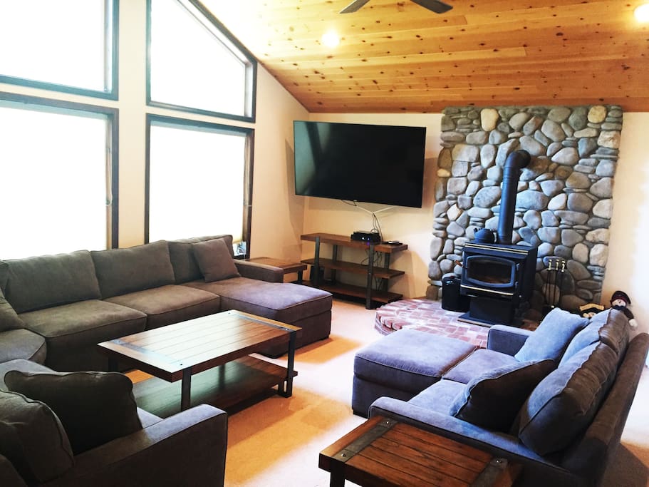Living Room with wood burning fireplace, 75" TV